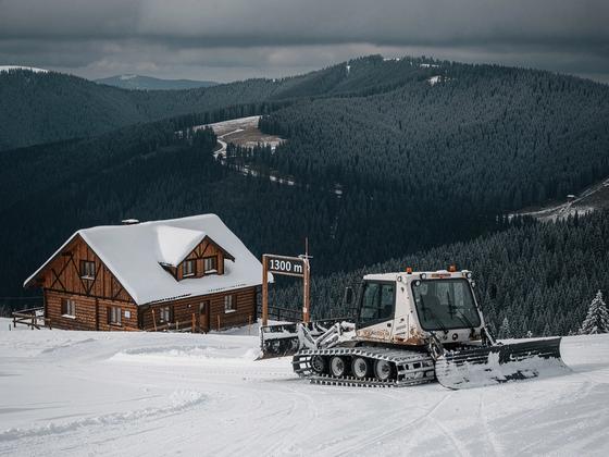 Slopes above Dragobrat with a snowcat and a lodge below